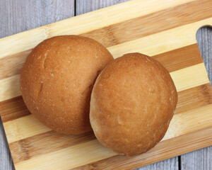 Fototapeta na wymiar Two rolls on a cutting Board. Wheat bread.