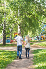 Fototapeta premium Romantic happy couple in the summer park. Rear view