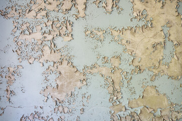 blue peeling paint on aged concrete wall texture