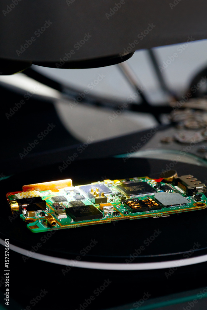 Poster nano technology concept background. micro chip matrix illuminated on a microscope table