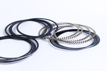 Fototapeta premium Spare parts for car piston rings on white isolated. New original equipment spare parts