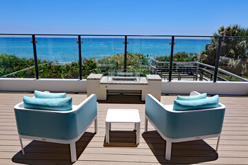 Inviting outdoor terrace with designer furniture overlooking the ocean.