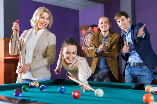 Relaxed  people playing billiard and darts as hanging out