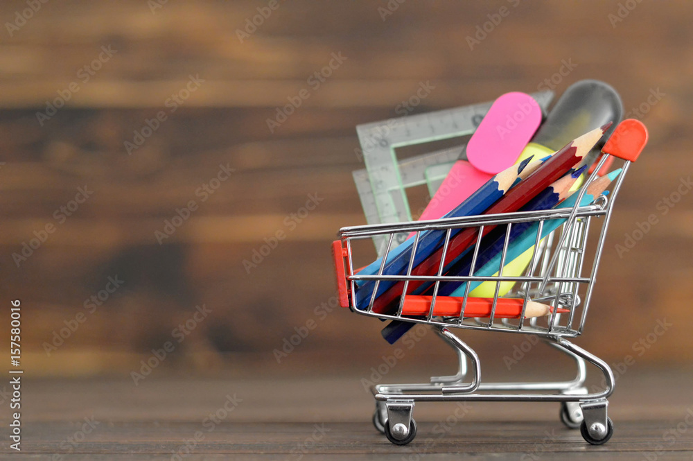 Wall mural back to school: school supplies in shopping cart