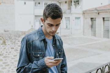 casual young man on the street with your mobile phone