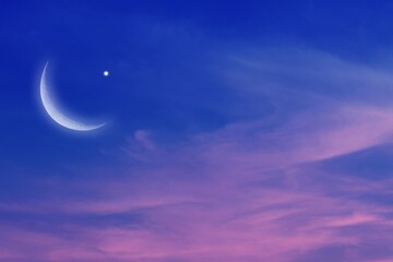 Sunset and new moon . Eid Mubarak background  .  Against the background of clouds . beautiful sky ....