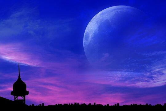 Sunset and new moon . Night city . Ramadan kareem background .mosque silhouette . Abstract religious eid background with mosque . full moon . Ramadan kareem background  