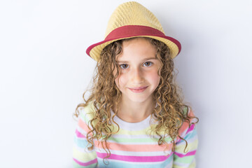 Portrait of 9 years old girl with curly hair, isolated on gray