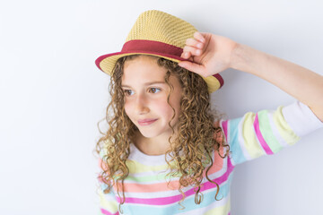 Portrait of 9 years old girl with curly hair, isolated on gray
