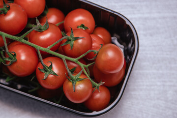 Cherry tomatoes in a plastic container.