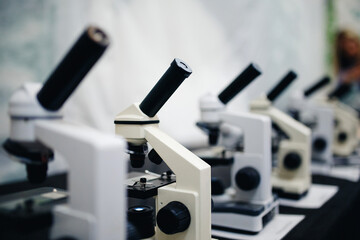Fototapeta na wymiar series of microscopes of monochrome color and with a glare. Concept of biology and research medical equipment.