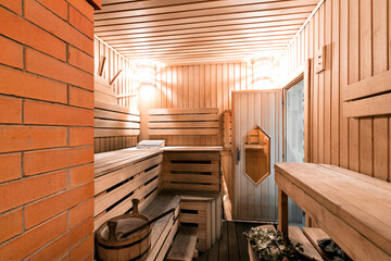 Empty wooden sauna room with ladle, bucket ready to be used