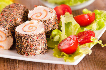 Goat cheese with salad and cherry tomatoes. 