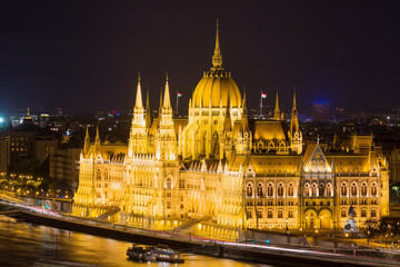 Fototapeta na wymiar Budapest parliament building at night with dark sky and reflection in Danube river