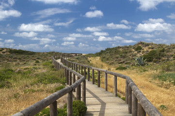 Fototapeta na wymiar Wooden walkway leading to Bordeira Beach, Algarve, Portugal
