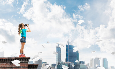 Concept of careless happy childhood with girl of school age looking in future