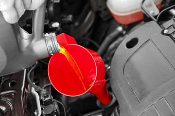 Engine oil pouring from canister, closeup