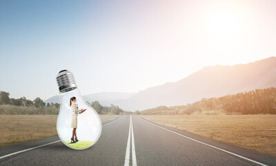 Businesswoman inside light bulb