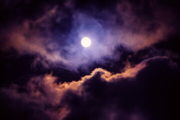 The moon on the dark sky among the clouds, natural abstract background