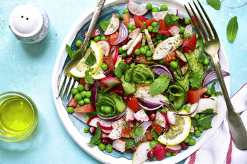 Summer colorful vegetable salad with chicken and mint.Top view.