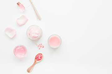 body treatment with rose extract and cosmetic set white desk background top view space for text