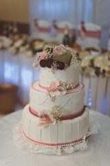 Obraz na płótnie Canvas White wedding cake, pink color decorate with flower