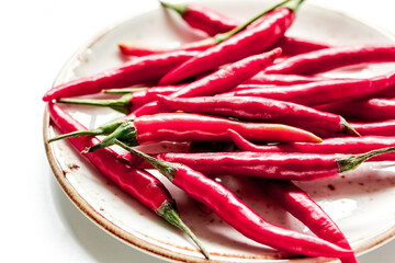 food ingredient red chilli pepper on white table background close up