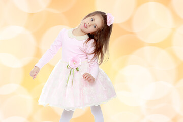 Elegant little girl in a pink dress.