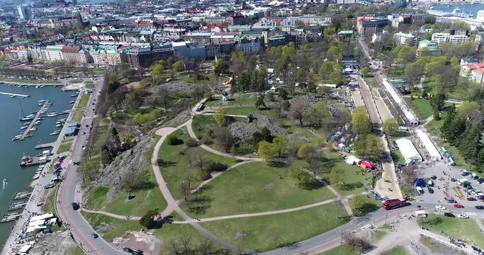 Kaivopuisto, Cinema 4k aerial pan view of a event at brunnsparken, on a sunny summer day, in Helsinki, Finland