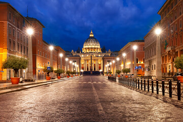 View of The Papal Basilica of St. Peter in the Vatican or Saint Peter Cathedral during morning blue hour in Rome, Italy.