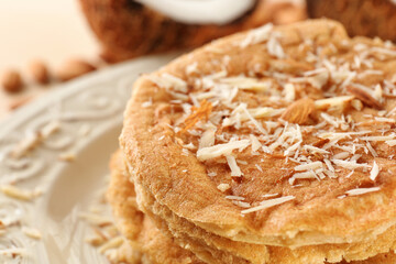 Delicious coconut pancakes decorated with almond shavings, close up