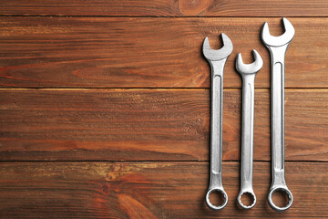 Combination wrenches on wooden background