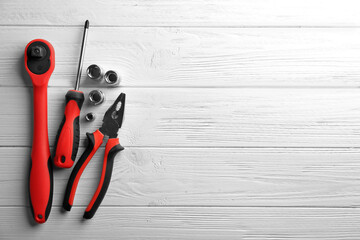 Setting of tools for car repair on white wooden background