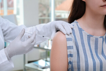 Young girl receiving vaccination in hospital