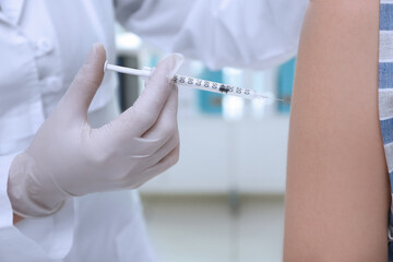 Young girl receiving vaccination in hospital