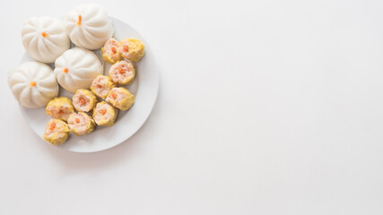 Fototapeta na wymiar Steamed dumplings top view fresh boiled with hot steams on white background Chinese food copy space