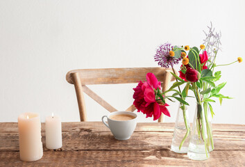Beautiful flowers in vases as floral decor on wooden table