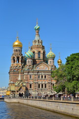 Fototapeta na wymiar The Cathedral of the Savior on blood is large and the Griboyedov canal embankment in the summer