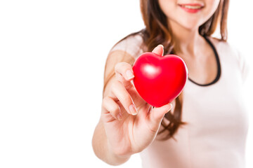 Young woman holding red heart on a white background.