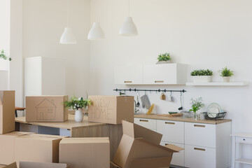 New home owners unpacking boxes, big cardboard boxes in new home. Moving to a new apartment concept