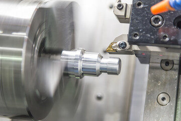  CNC lathe machine (Turning machine) while cutting the aluminium screw thread.Hi-precision CNC machining concept.