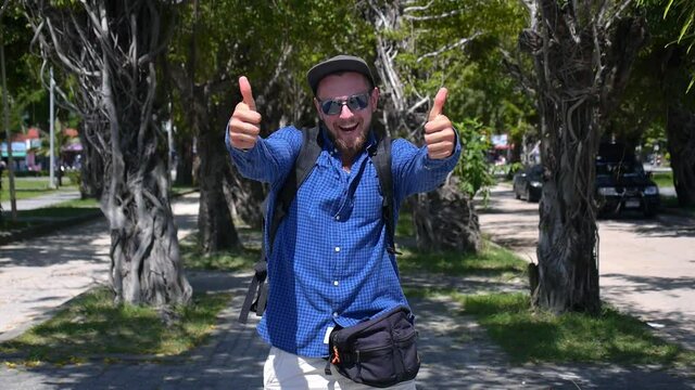 Happy Traveler Man With Backpack Shows Thumbs Up. HD, 1920x1080.