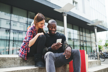 Interracial couple resting after shopping