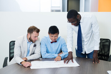 Fototapeta premium Three business people in conference room