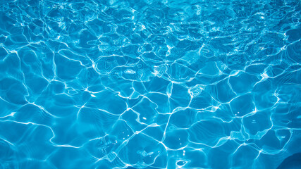 Fototapeta na wymiar Blue water surface in swimming pool