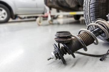 closeup wheels and shock absorbers with repair the suspension on the car. soft-focus and over light