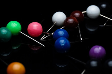 close up of colorful thumbtack isolated on black
