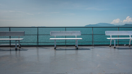 Fototapeta na wymiar White wooden bench and sea view.