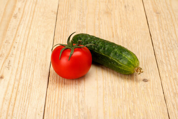 Cucumber tomatoes on a white wooden background