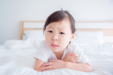 Little asian girl feel boring on bed